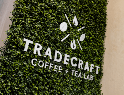 Tradecraft Lab Logo Tradecraft Coffee & Tea Lab Logo on a green plant wall