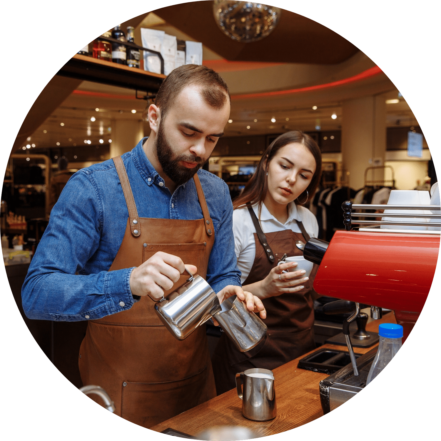 Barista Family Male barista training female barista on how to make coffee