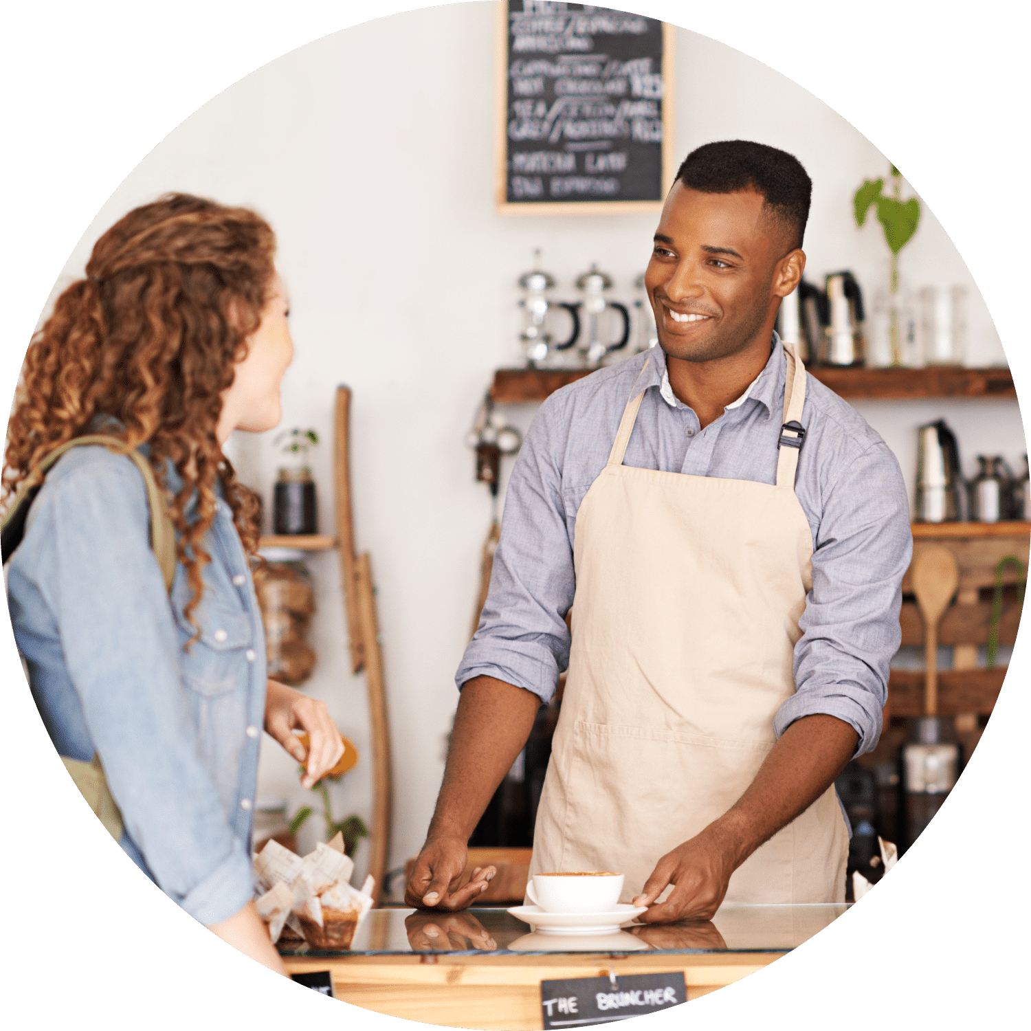 Barista and Customer Talking Male barista talking to a female customer while sliding her coffee