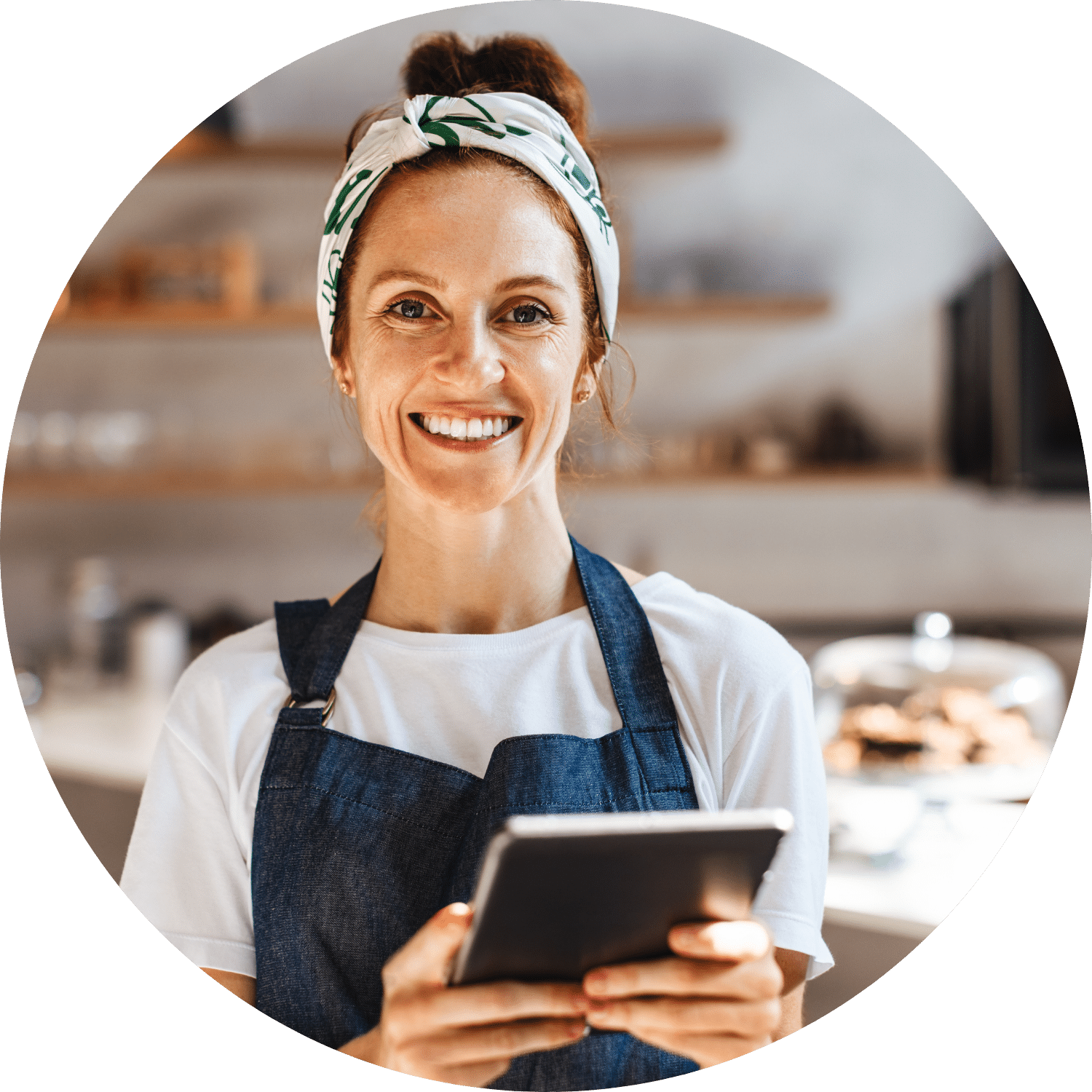 Female Barista with Tablet Female barista smiling and holding a tablet while wearing an apron