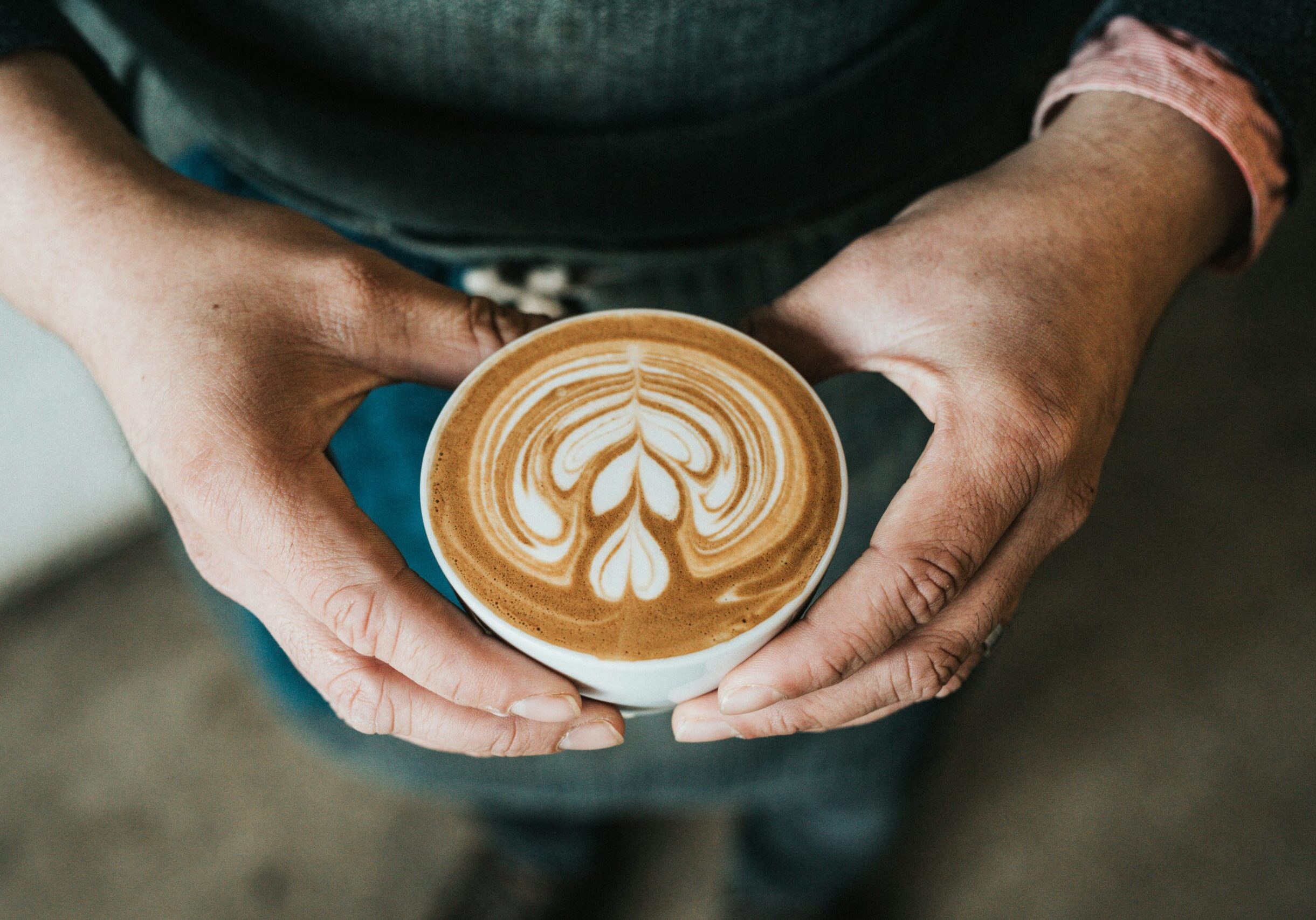 Customer holding latte art, cappuccino